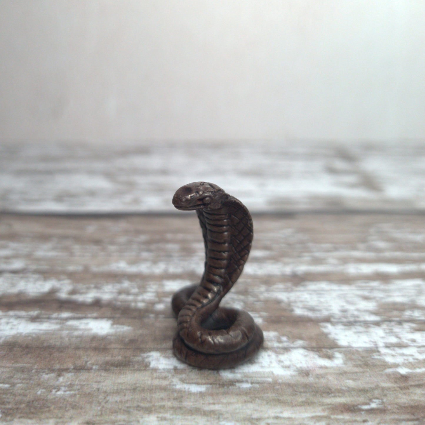Miniature foundry-cast bronze cobra sculpture with dark patina by David Meredith at Alcove Art