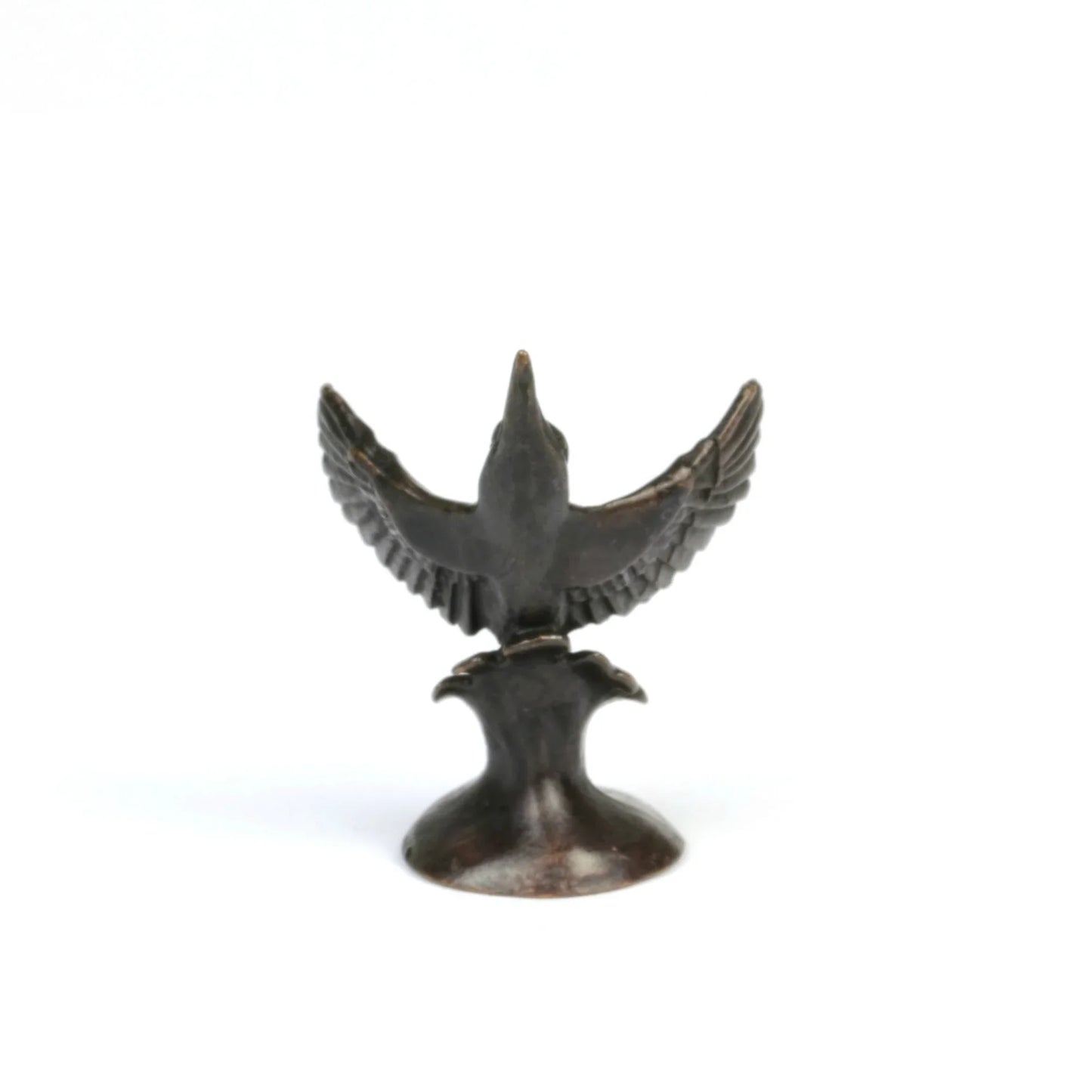 Back view of a miniature bronze kingfisher sculpture on a white background