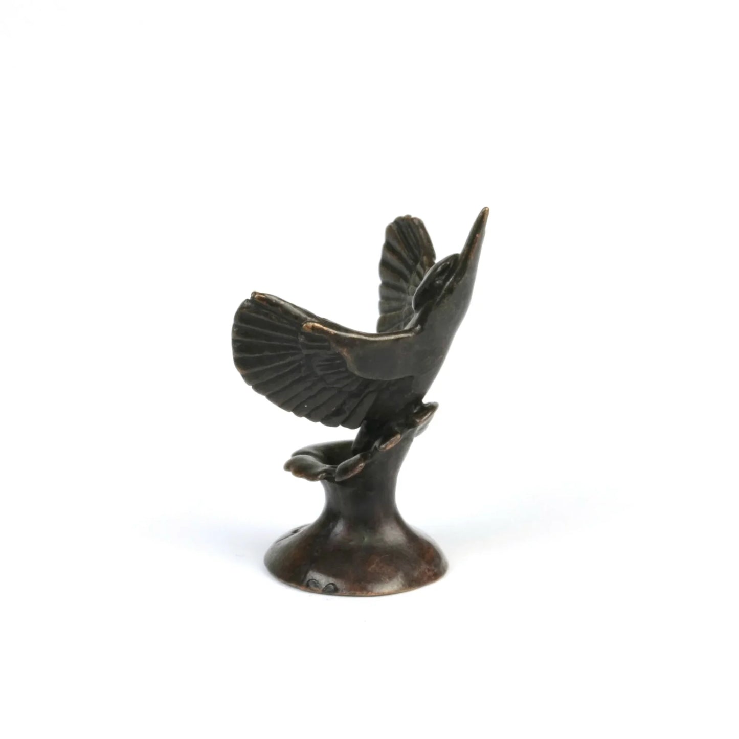 Side view of a miniature bronze kingfisher sculpture on a white background