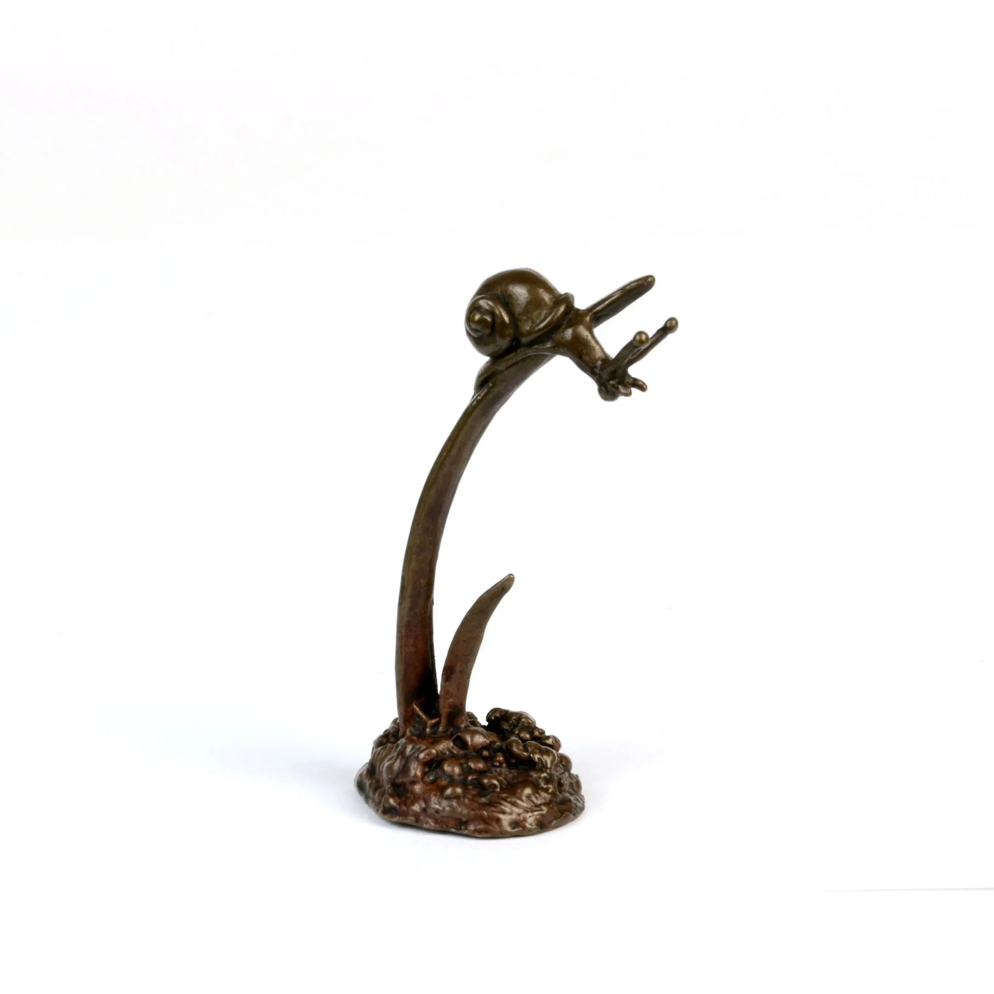 A miniature bronze snail perched on the end of an upright bronze leaf, facing right, against a white background